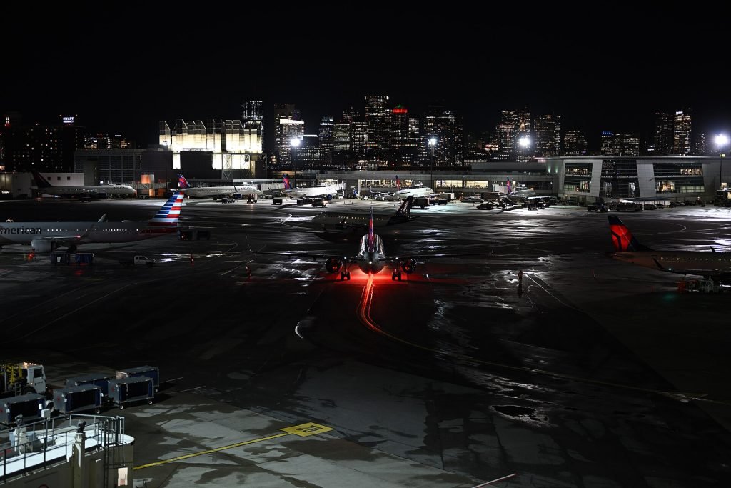 Boston Logan International Airport at night with skyline