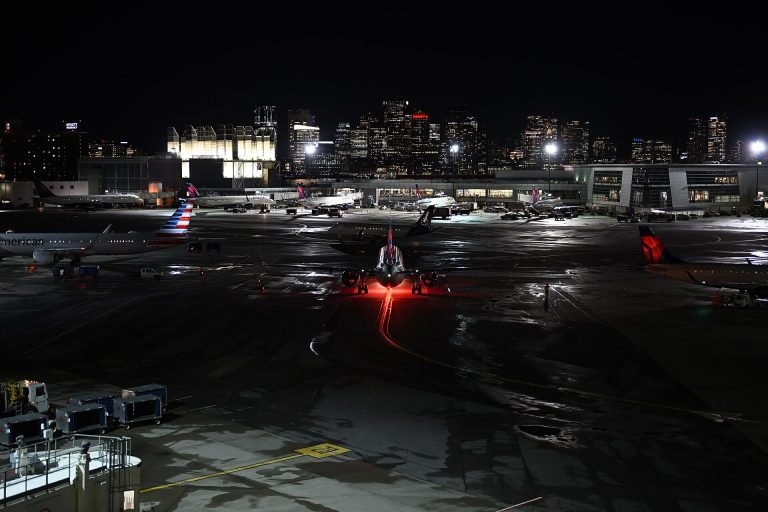 Boston Logan International Airport at night with skyline